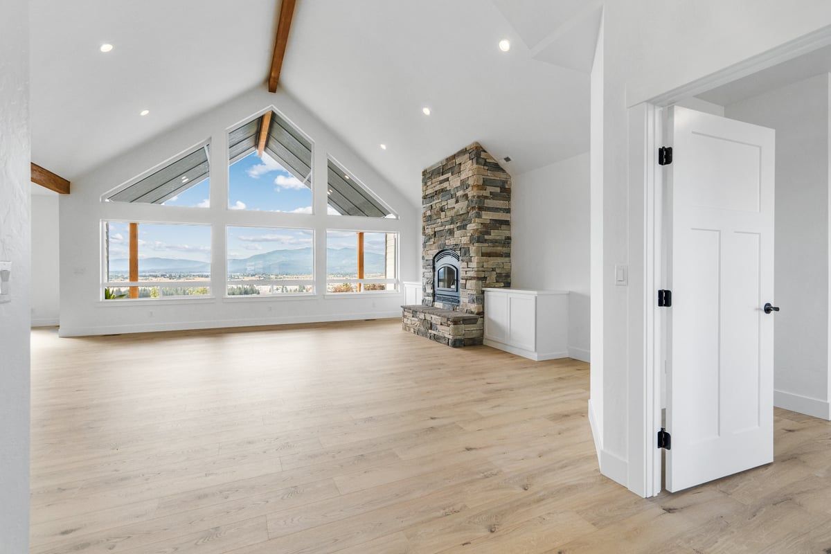 Vaulted great room with stone fireplace in a Ridge at Hauser home